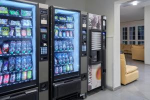 two soda machines in a room with soda cans at Marittima Rooms in Milano Marittima