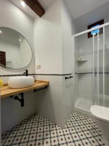 a bathroom with a shower and a sink and a mirror at Hammam de Zeid in Toledo