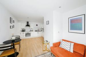 a living room with a couch and a table at Cozy 1bedroom flat in Romford in Romford