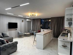 a kitchen and living room with a couch and a table at Apartment in Erebuni in Yerevan