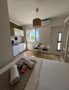 a room with a bed with two pillows and a kitchen at Studio apartman Nela in Murter +7 photos
