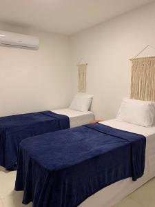 A bed or beds in a room at Kanui Milagres ER Hospedagens