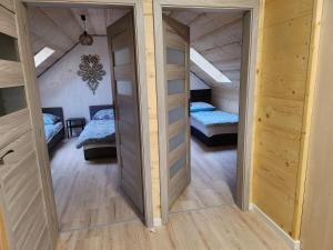 a room with two beds and two bunk beds at Domek rodzinny in Piekielnik