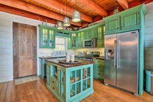 a kitchen with green cabinets and a stainless steel refrigerator at Lakefront Lewisburg Vacation Rental with Deck! in Lewisburg +18 photos