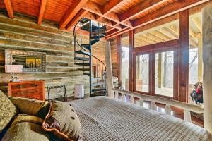 a bedroom with a bed in a log cabin at Lakefront Lewisburg Vacation Rental with Deck! in Lewisburg