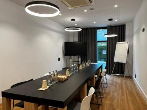 a conference room with a long black table and chairs at Holiday Inn Express Bilbao Airport, an IHG Hotel in Derio