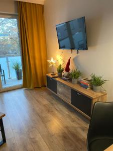 a living room with a flat screen tv on the wall at Apartament Tomek in Iława