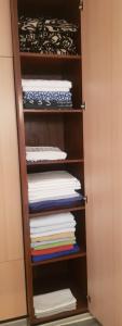 a closet with a stack of folded towels at STAN 54m2 in Priboj
