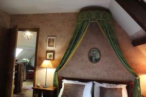 a bedroom with a bed with a canopy at La Renaudiere en bourgogne in Gergy
