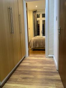um corredor que leva a um quarto com uma cama em Amazing Studio Apartment in North East London em Londres