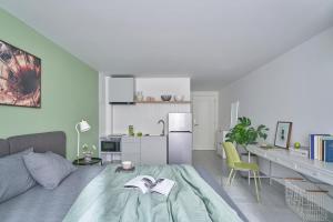 a bedroom with a bed with a book on it at M Village Living Cửu Long in Ho Chi Minh City