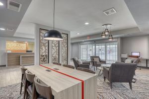 a conference room with a table and chairs at Candlewood Suites Milwaukee Airport - Oak Creek by IHG in Greendale