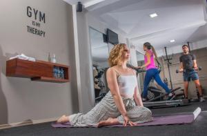 a woman sitting on the floor in a gym at Fenix Hotel in Quito