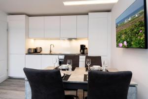 a kitchen and dining room with a table and chairs at Albatros OG in Tinnum +12 photos