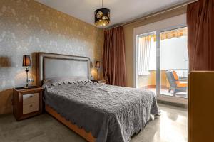 a bedroom with a bed and a large window at Ocean view Family Apartment in Playa La Arena in Puerto de Santiago