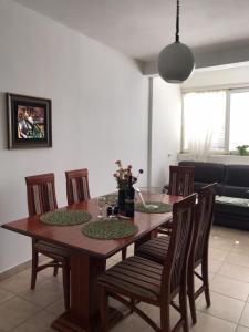 a dining room table and chairs in a room at Apartman Lana in Bajina Bašta