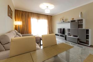 a living room with a couch and a table at Ocean view Family Apartment in Playa La Arena in Puerto de Santiago