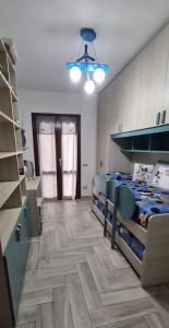 a bedroom with two bunk beds and a bathroom at Casa Laura, Quartu Sant'Elena in Su Forti