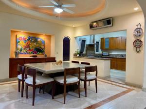a kitchen with a dining room table and chairs at Villa Navarro: Marina Vallarta in Puerto Vallarta