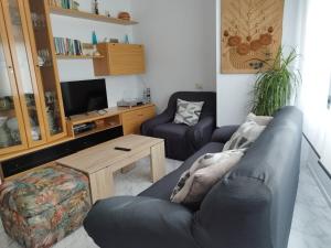 a living room with a couch and a table at Vistas Al Mar E Isla De La Toja in O Grove
