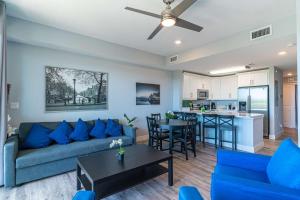 a living room with a blue couch and a kitchen at 3274 Little Harbor in Ruskin