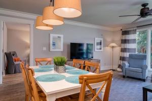 a dining room and living room with a table and chairs at Lagoon Villa 43 - Close to Ocean! Easy Access to Resort! in Isle of Palms