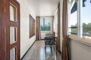 a hallway with a chair and a window at 345AB Sai Gon Hotel in Ho Chi Minh City