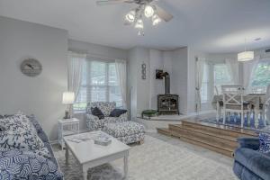 a living room with a couch and chairs and a fireplace at Lighthouse Seclusion in Ocean Pines
