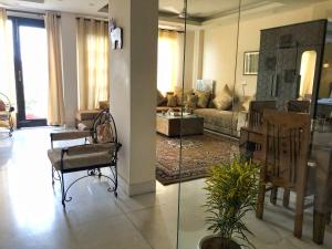 a living room with a couch and a table at Avatar Living@ Greater Kailash 2 in New Delhi