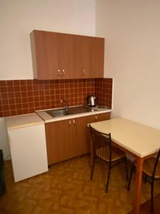 a small kitchen with a table and a sink at Villa Osmani in Durrës