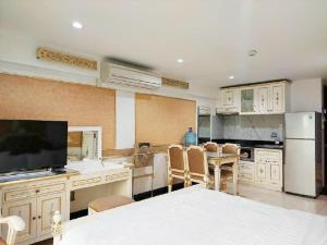 a kitchen with a table and chairs and a television at 345AB Sai Gon Hotel in Ho Chi Minh City