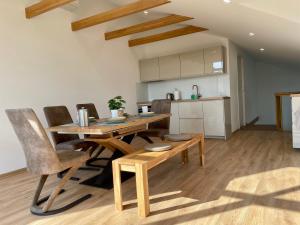 a kitchen and dining room with a wooden table and chairs at Relax Baltic in Klaipėda