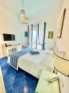 a bedroom with a large bed with a blue floor at Hotel Villa Delle Palme in Positano in Positano