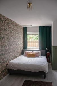 a bedroom with a bed and a window at Hostel Barbarossa in Nijmegen