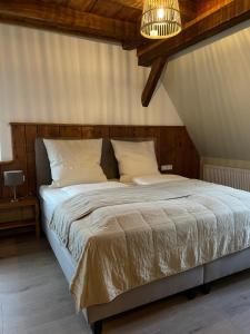 a bedroom with a large bed with a wooden ceiling at Altes Rathaus in Schwaigern