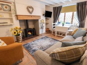 a living room with a couch and a fireplace at Hilston in Rhyl
