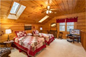 a bedroom with two beds and a ceiling fan at A Rustic Hideaway in Todd