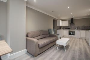 a living room with a couch and a table at Riverside Central Kingston Flat 1B in Surbiton +14 photos