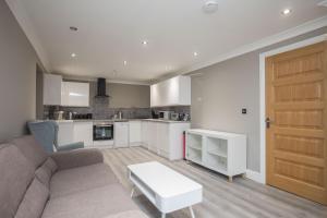 a living room with a couch and a table at Riverside Central Kingston Flat 1B in Surbiton
