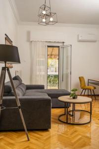 a living room with a couch and a table at Classy & Comfy 1 BD Apt 4' to Acropolis in Athens