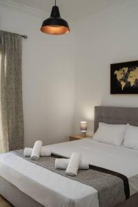 a bedroom with two beds and a pendant light at Classy & Comfy 1 BD Apt 4' to Acropolis in Athens