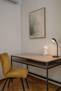 a desk with a lamp and a chair in a room at Classy & Comfy 1 BD Apt 4' to Acropolis in Athens