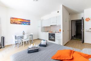 a bedroom with a kitchen and a table with chairs at Il Nido Di Giambra in La Spezia