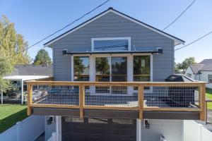a house with a large deck with a dog on it at Tranquil Charm in Redmond