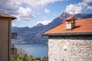 a building with a view of a lake and mountains at Il Vecchio Torchio in Perledo
