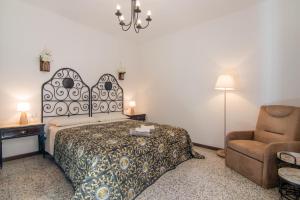 a hotel room with a bed and a chair at Il Vecchio Torchio in Perledo