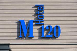 a blue sign on the side of a building at Hotel M120 in Munich