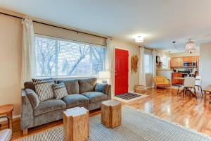 a living room with a couch and a red door at Cascade Comfort in Redmond