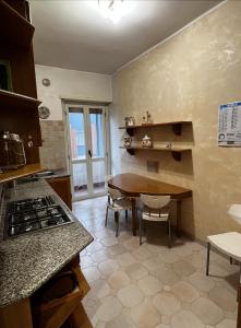 a kitchen with a table and a dining room at Appartamento Nonna Carmela in Pescara