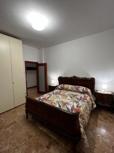 a bedroom with a bed in a room with two tables at Appartamento Nonna Carmela in Pescara